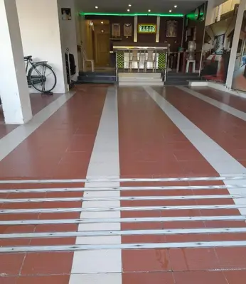 a hallway of a building with a red and white floor at SUPREME RESIDENCY in Coimbatore