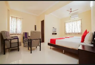 a bedroom with a bed and a desk and a chair at HOTEL LEMONADE in Coimbatore