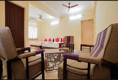 a living room with chairs and a couch at HOTEL LEMONADE in Coimbatore