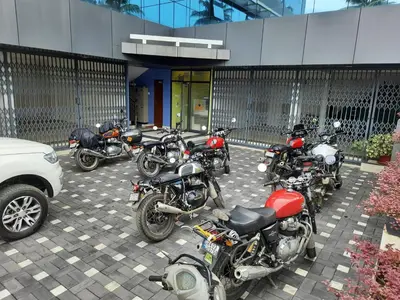 a row of motorcycles parked in front of a building at Emerald Royal Residency in Cochin
