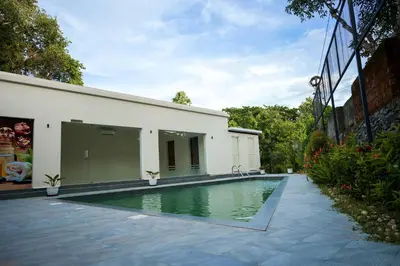 a swimming pool in front of a building at Valluvanad Residency in Perintalmanna
