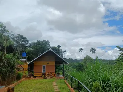 a small house in the middle of a field at Agronest Farm by LivingStone in Sultan Bathery