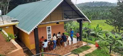 a group of people standing outside of a house at Agronest Farm by LivingStone in Sultan Bathery