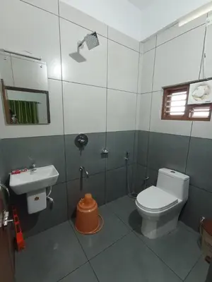 a bathroom with a toilet and a sink at Besrauma Vythiri in Vythiri