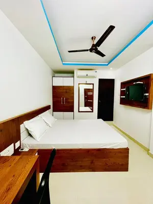 a bedroom with a bed and a ceiling fan at Zam Zam Residency in Cheruppulasseri