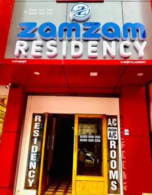 a sign for a korean restaurant in front of a door at Zam Zam Residency in Cheruppulasseri