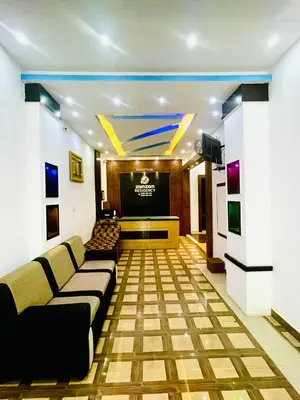 a living room with a couch and a projection screen at Zam Zam Residency in Cheruppulasseri