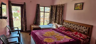 a bedroom with a bed and a window at Karpagam Residency in Ooty