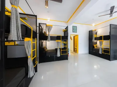 a room with two bunk beds with nets at The Hosteller Coorg, Madikeri in Madikeri