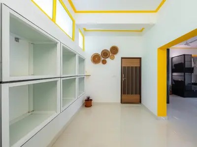 a hallway with glass shelves and a door at The Hosteller Coorg, Madikeri in Madikeri