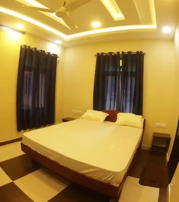 a bedroom with a large bed in front of a window at Meghdoot river resort in Ernakulam