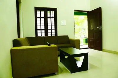 a living room with a couch and a coffee table at Shibi's Tea Garden Heritage in Vayittiri