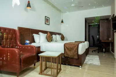a hotel room with a bed and a couch at THE RUNWAY HOTEL in Cochin