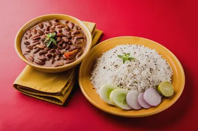 a plate of food with rice and a bowl of soup at Super Collection O Coorg in Madikeri