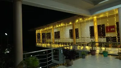 a balcony with lights on the side of a building at AC MIST in Munnar