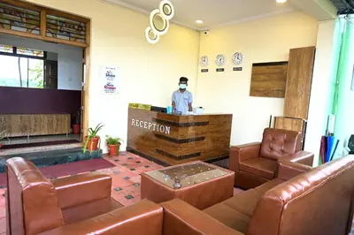 a man standing at a bar in a waiting room at Hotel Stay Shine in Mysore