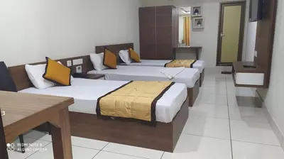 a group of four beds in a room at Kallada Residency in Perintalmanna