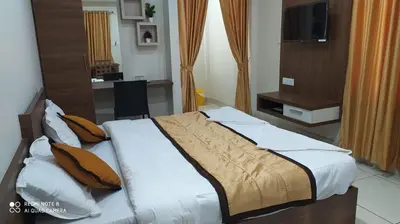 a bedroom with a large bed in a room at Kallada Residency in Perintalmanna
