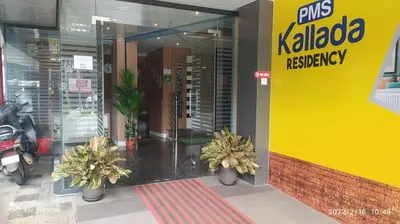 a store entrance with potted plants in front of it at Kallada Residency in Perintalmanna