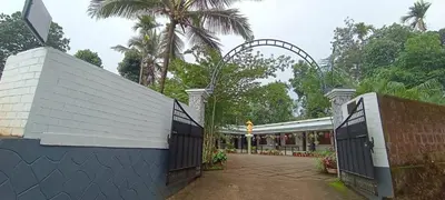 an entrance to a building with a gate at Pauls Retreat Wayanad , Family Resort in Wayanad