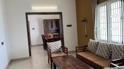 a living room with a couch and a table at PPH Living Athithi Inn Corporate Stay in Coimbatore