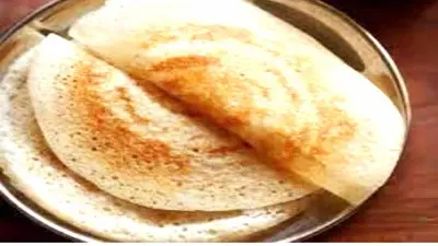 two pancakes sitting on a pan on a table at PPH Living Athithi Inn Corporate Stay in Coimbatore