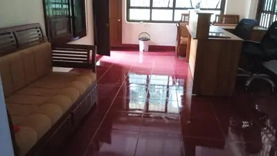 a living room with a red tiled floor and chairs at Avadale Coorg - Stag Groups Not Allowed in Ammatti