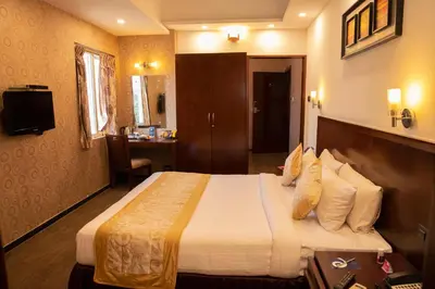 a bedroom with a large bed in a hotel room at THE PEBBLE Boutique Hotel in Tiruppūr