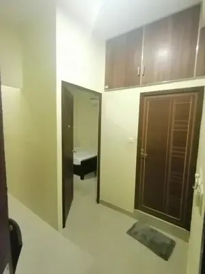 a small room with a door and a bench in it at Queens Residency in Trichūr