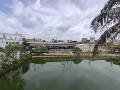 a body of water in front of a city at Green Garden Apartments in Kodungallūr