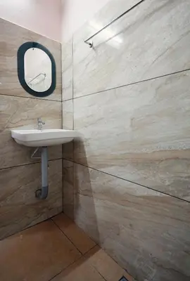 a bathroom with a sink and a mirror at Chakalakkal Residency in Sultan Bathery