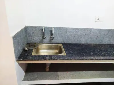 a kitchen counter with a stainless steel sink at Forestay -3 BHK Villa Kochi in Pallipuram