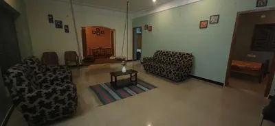 a living room with two couches and a table at SHI's Triveni Spacious 2BHK Villa in Pappampatti, Coimbatore in Coimbatore