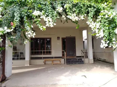 an entrance to a building with white flowers at SHI's Triveni Spacious 2BHK Villa in Pappampatti, Coimbatore in Coimbatore