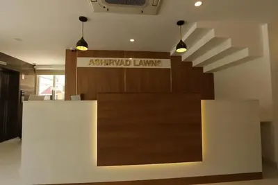 a lobby with a desk and a sign in a building at Ashirvad Lawns Hotel & Convention Centre in Kozhikode