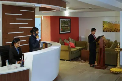 a group of people in a waiting room at Emarald Hotel Calicut in Kozhikode