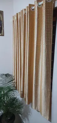 a row of beaded curtains in a room with a plant at NEST Mdy in Mananthavady