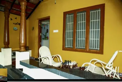 a group of white chairs sitting in a room at A Chettinad villa in Coimbatore on the way to Adiyogi and nearer to Maruthamalai in Coimbatore