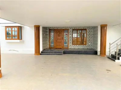 an empty room with a wooden door and stairs at Coimbatore Premium Private Villa a FAMILY RESORT kids, celebration hall in Coimbatore