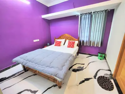a purple bedroom with a bed and a purple wall at Coimbatore Premium Private Villa a FAMILY RESORT kids, celebration hall in Coimbatore
