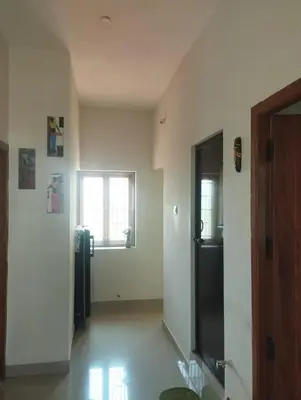 an empty room with a refrigerator and a window at SHI's Bhairavi Peaceful 2bhk villa - - On the way 2 isha-Adiyogi , Maruthamalai in Coimbatore