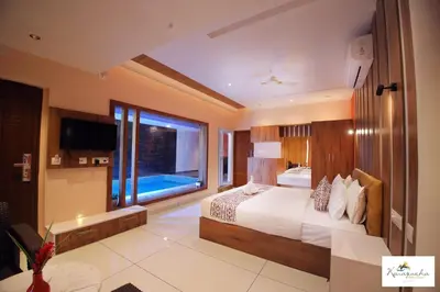 a bedroom with a large bed and a large window at Karapuzha Village Resort in Wayanad
