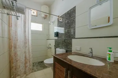 a bathroom with a sink and a toilet at LikeMyVilla 3bedroom villa in Vānivilāsa Puram