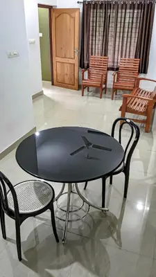 a black table and two chairs in a room at Shangri-laa hotel apartments in Tāzhekkod