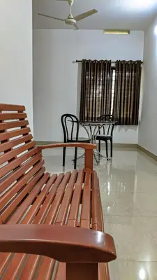a bench in a room with chairs and a table at Shangri-laa hotel apartments in Tāzhekkod