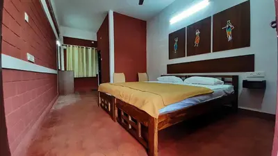 a bedroom with a large bed in a room at Deepwoods Stay-Kinathukadavu, Coimbatore in Coimbatore