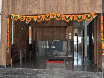 an entrance to a building with a garland at Lakshmi Paradise Lodge A/C in Pollāchi