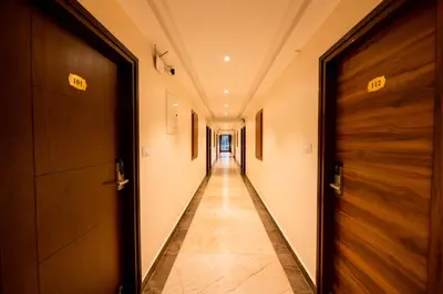 a hallway with two doors and a long corridor at KK Comforts in Shrīrangapattana