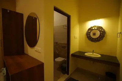 a bathroom with a sink and a mirror at Hotel PSY in Mettuppālaiyam
