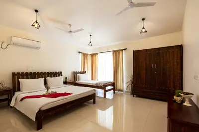 a bedroom with a large bed in a room at ama Stays & Trails Arcadia, Coorg in Madikeri